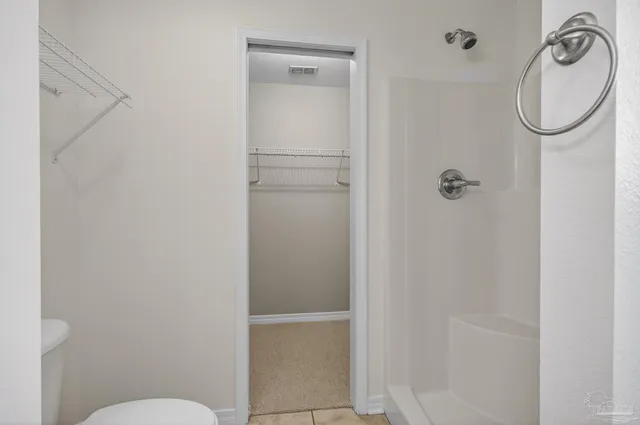 a view of a room with wooden floor and fence