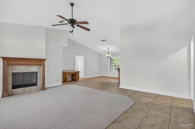 a view of a livingroom with a fireplace and ceiling fan
