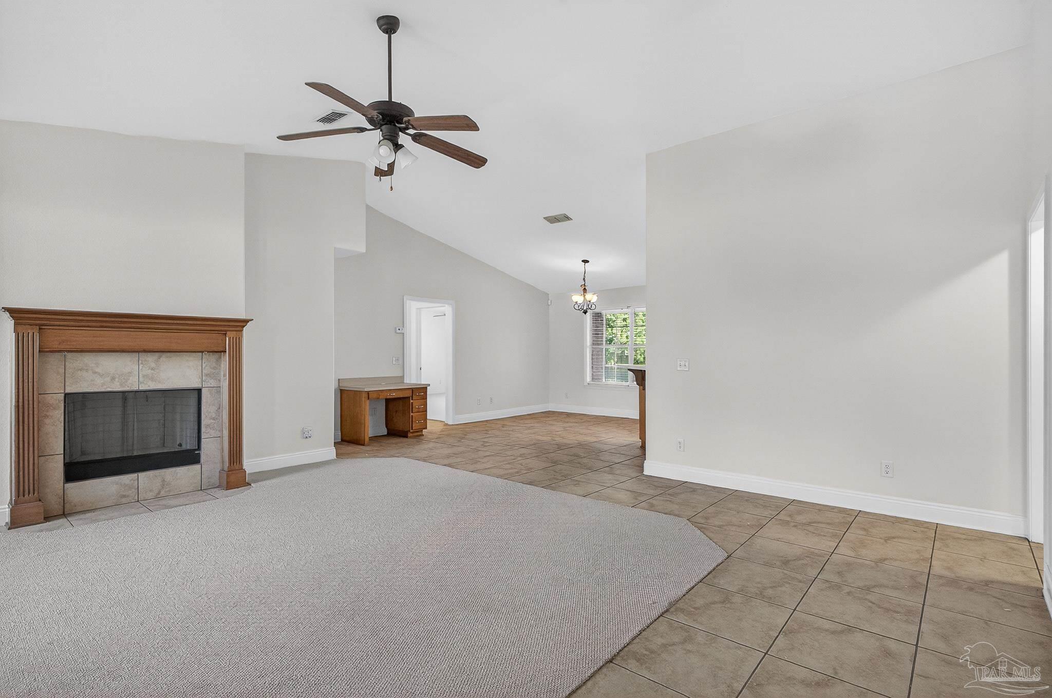 6050 Antelope Street Milton, FL 32570 - Photo 5 of 58 a view of a livingroom with a fireplace and ceiling fan