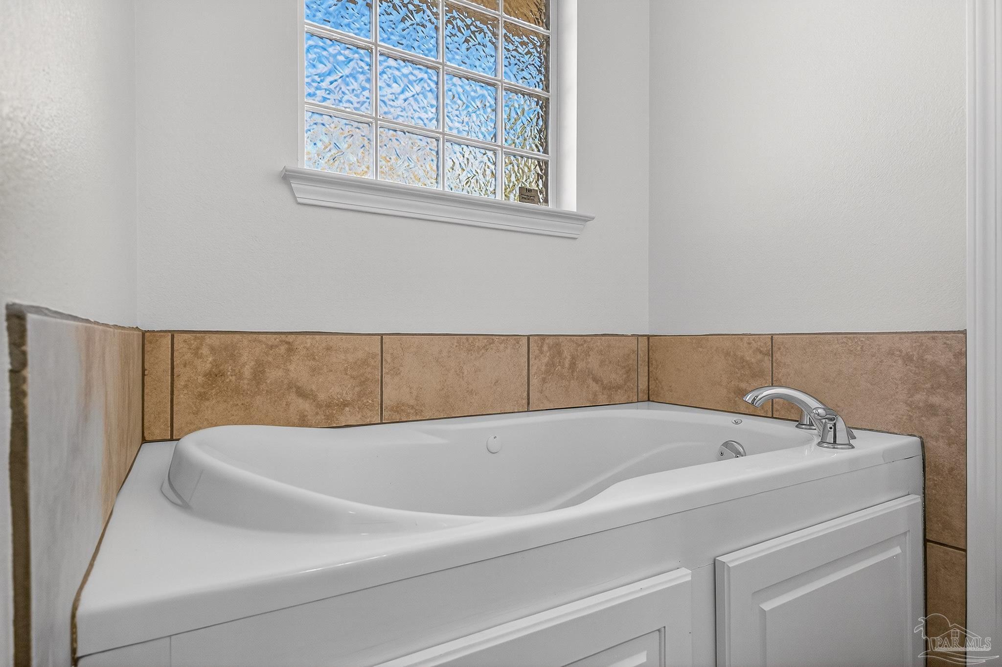 6050 Antelope Street Milton, FL 32570 - Photo 51 of 58 a bathroom with bathtub and window