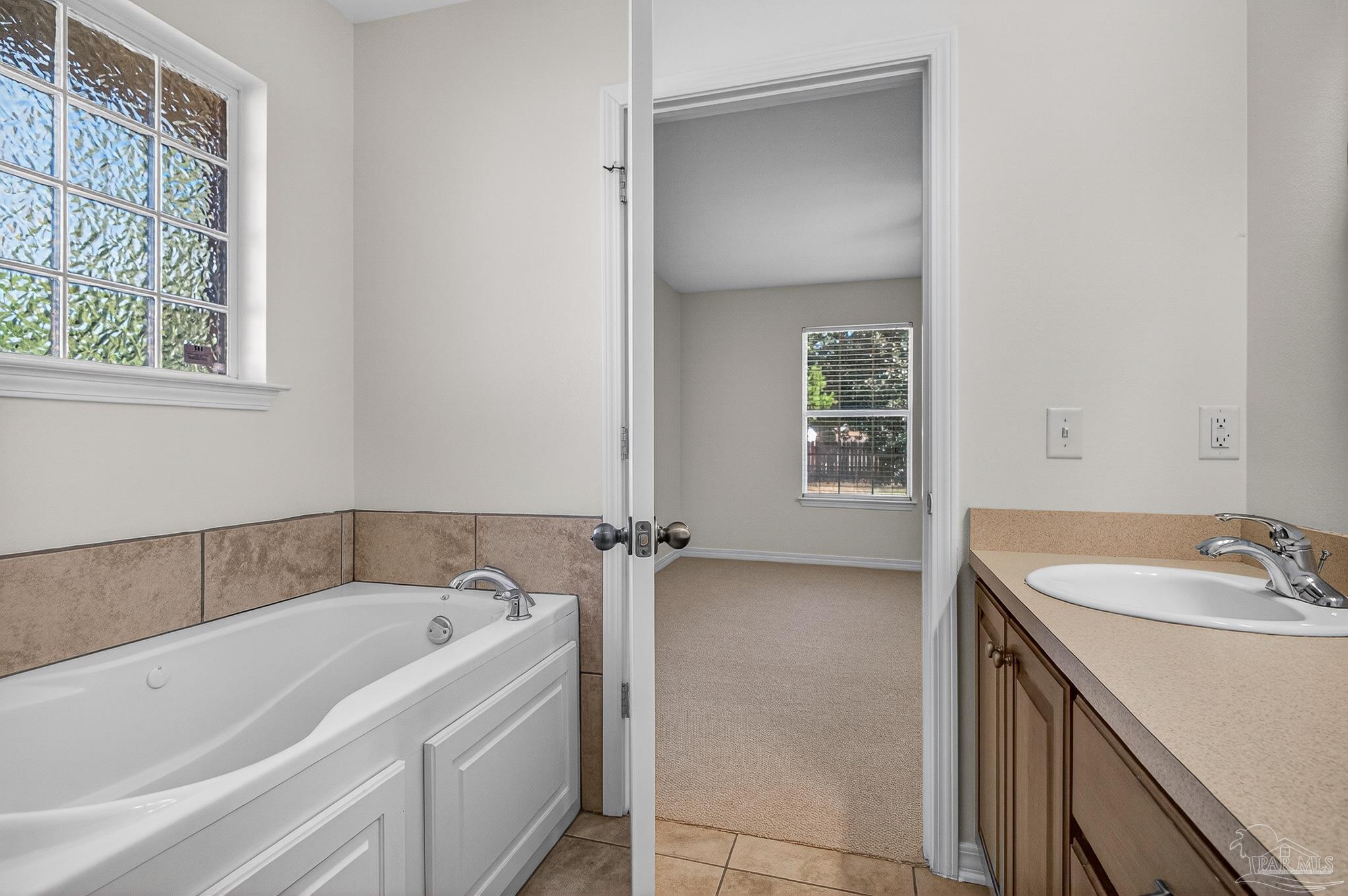 6050 Antelope Street Milton, FL 32570 - Photo 52 of 58 a bathroom with a sink and a bathtub