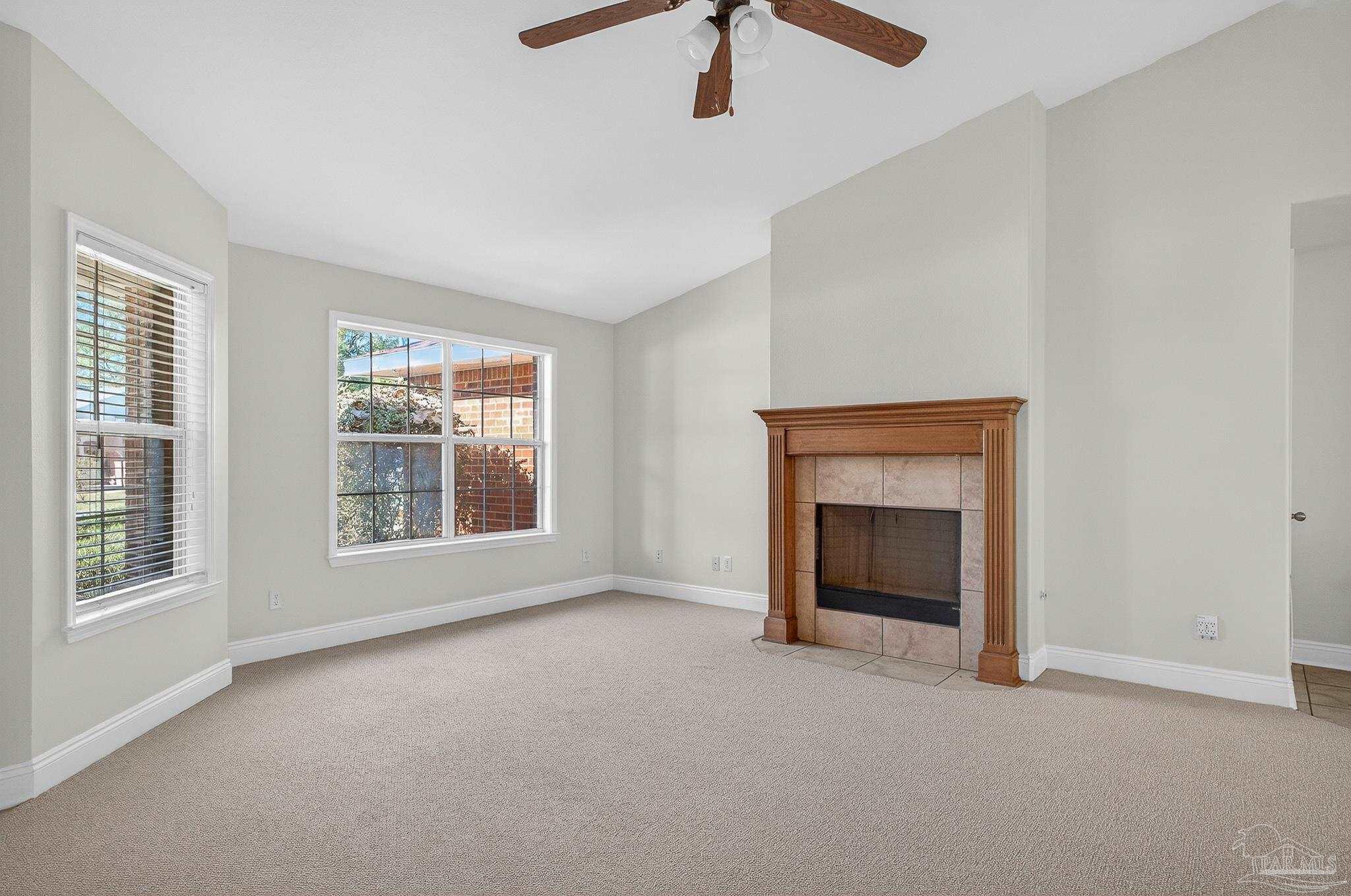 6050 Antelope Street Milton, FL 32570 - Photo 7 of 58 an empty room with windows and fireplace