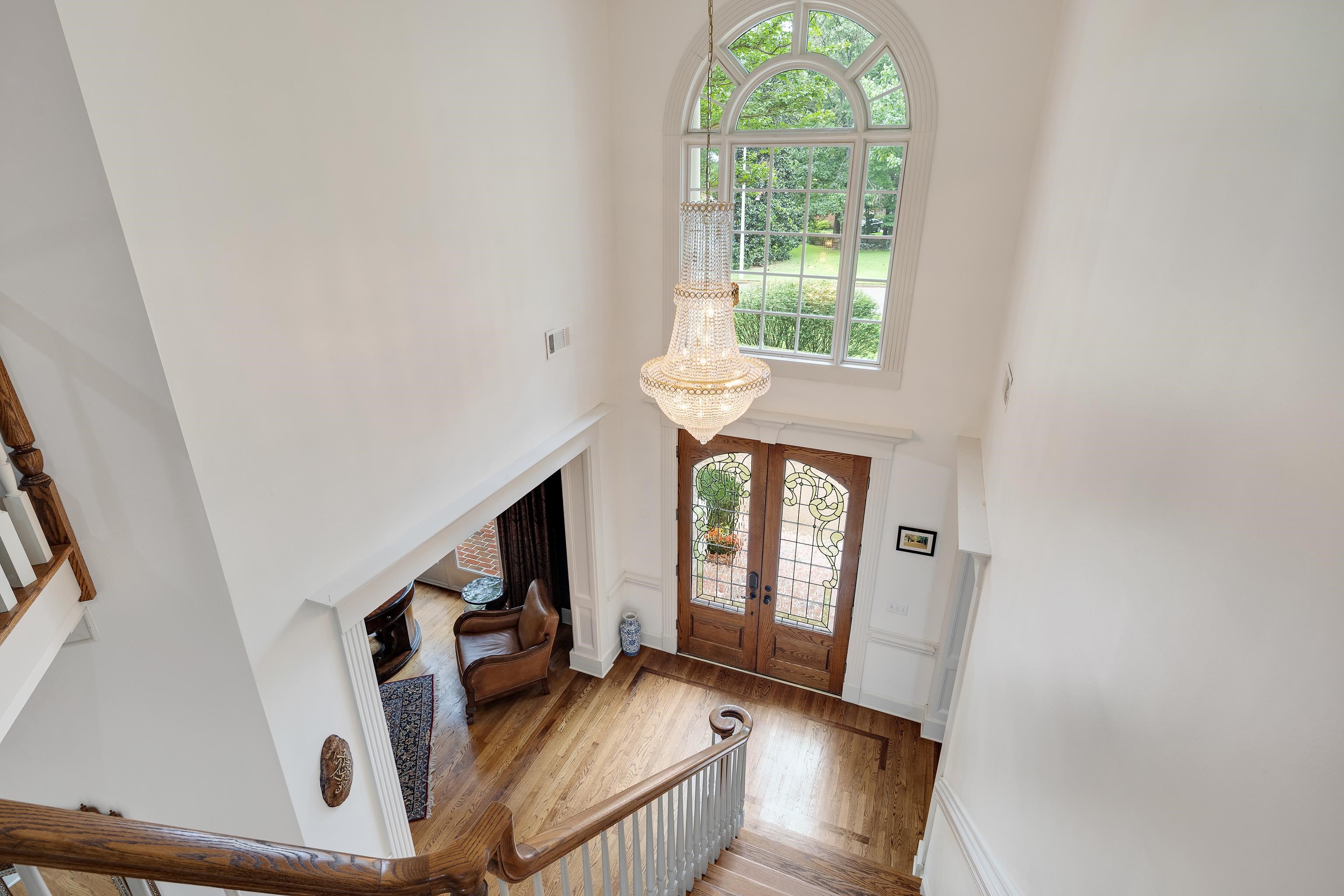 350 Bluff Ridge Cove Memphis, TN 38018 - Photo 11 of 37 Two-story foyer featuring hardwood flooring, a grand chandelier, a large arched window, and double entry doors with decorative glass inserts