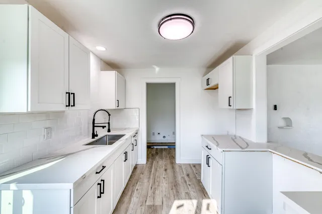 a bathroom with a double vanity sink a mirror and a shower