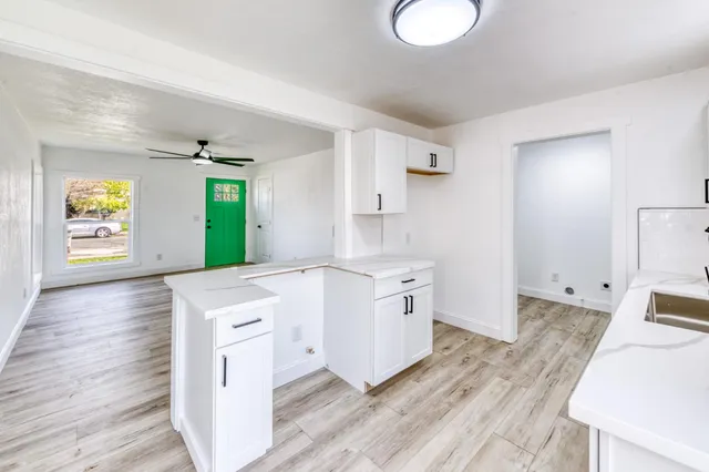 a kitchen with granite countertop a stove a sink and a refrigerator