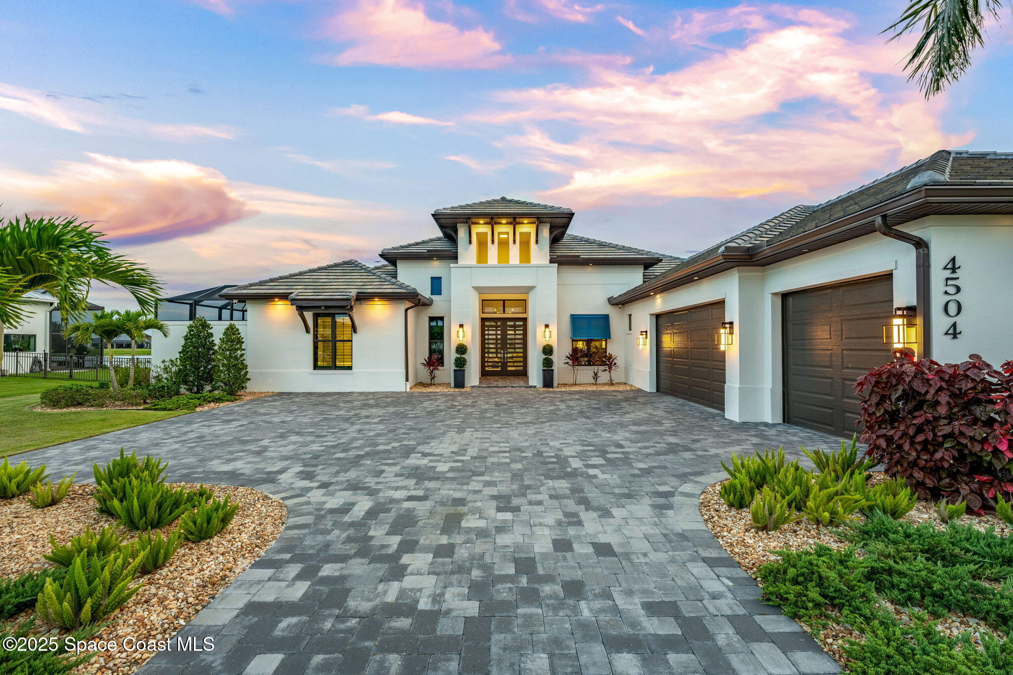 a front view of a house with garden