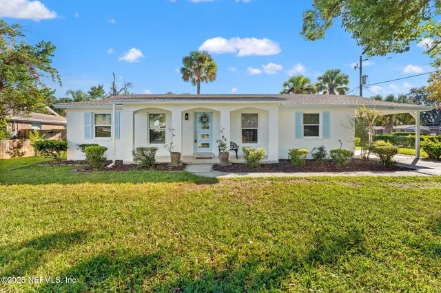 a front view of house with yard and outdoor seating
