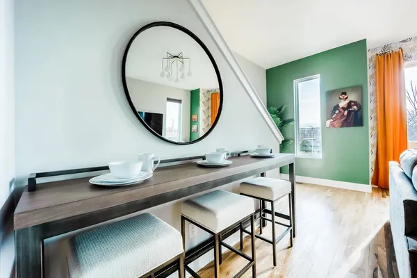 a bathroom with a sink a mirror and a painting on the wall