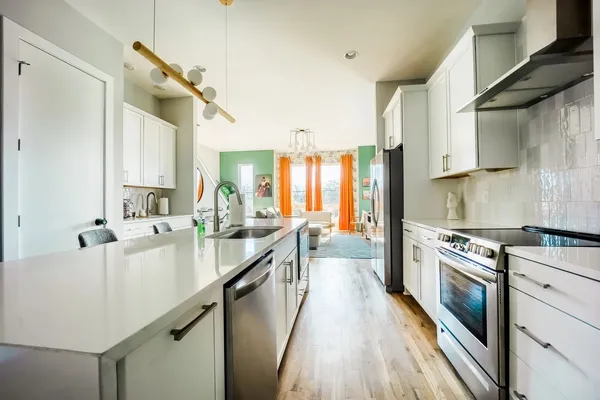 a large kitchen with a lot of counter space and a sink