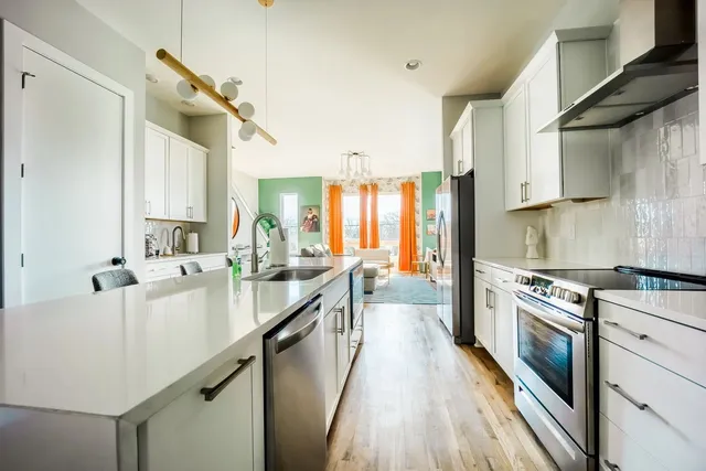 a large kitchen with a lot of counter space and a sink