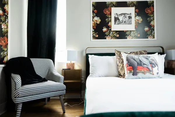 a bedroom with a bed and a large window