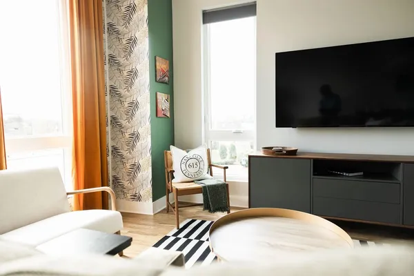 a bedroom with a bed and flat screen tv