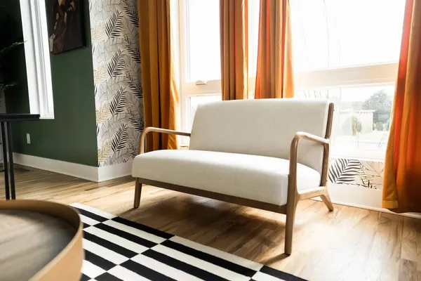 a living room with a bed furniture and a large window