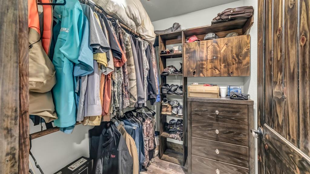 1140 Garvey Ranch Road Loving, TX 76460 - Photo 12 of 40 a view of walk in closet with clothes and shoes