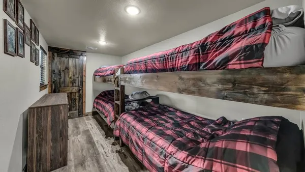 a bedroom with bed and a chandelier