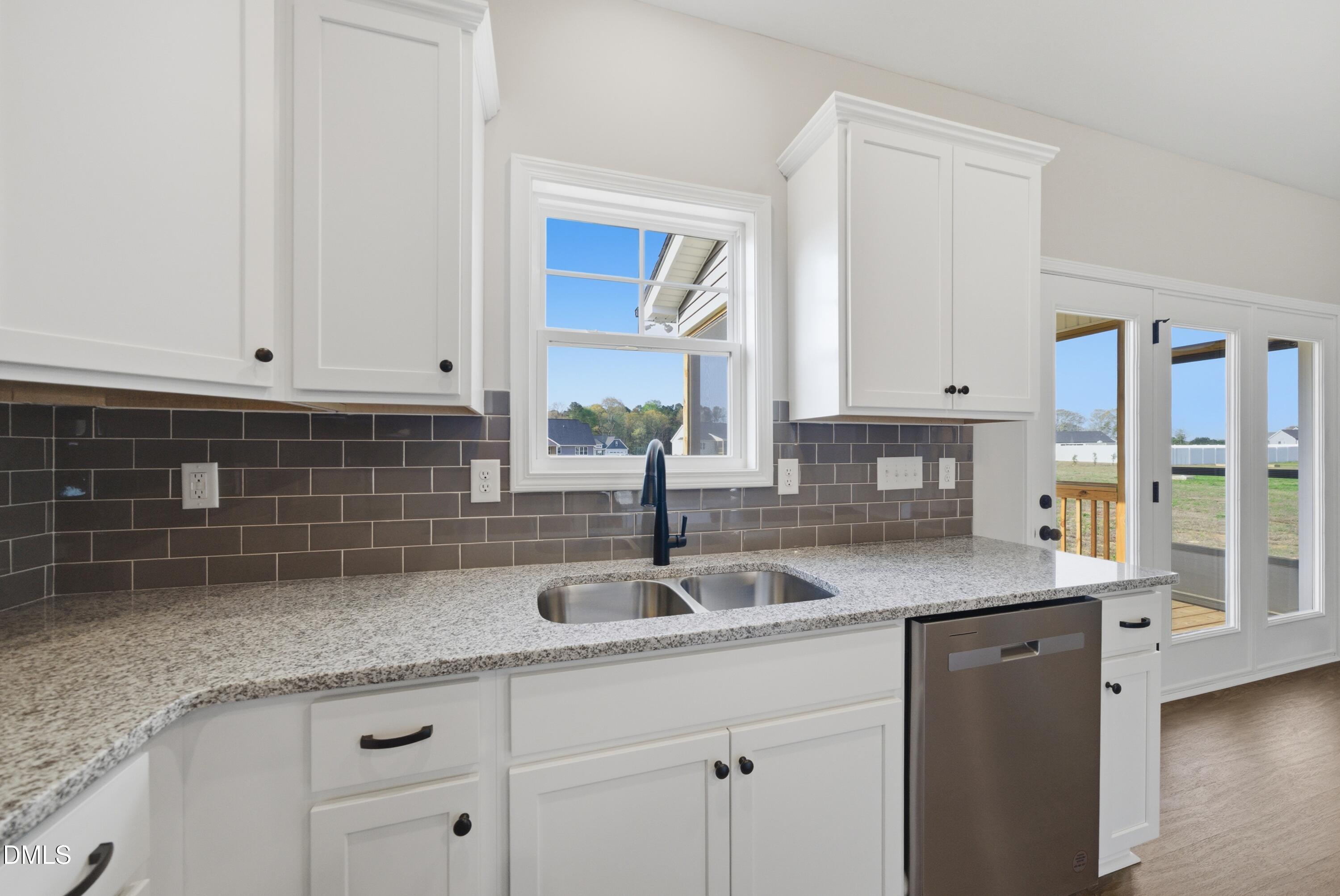 9315 Turkey Way Middlesex, NC 27557 - Photo 11 of 34 a kitchen with granite countertop a sink and white cabinets