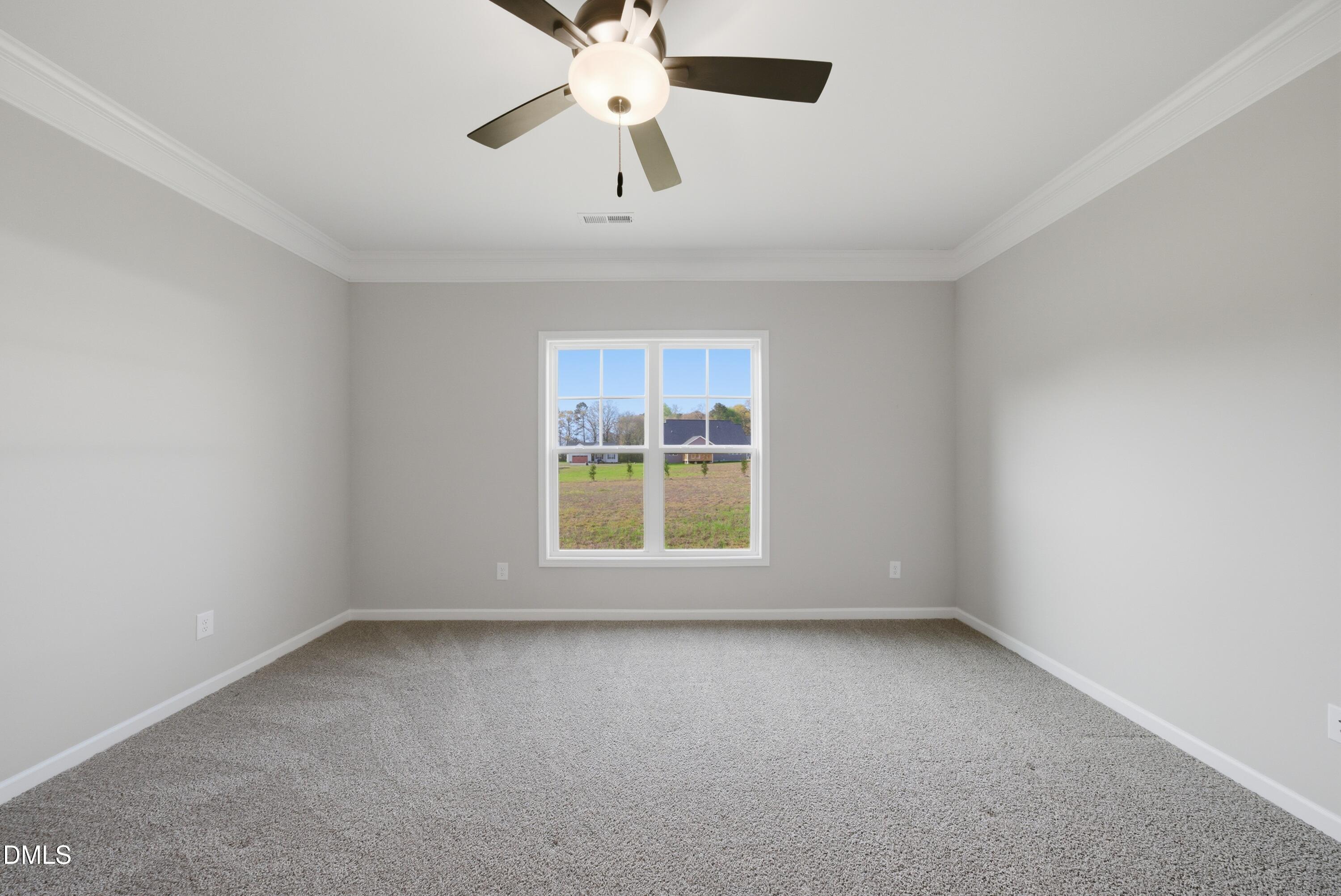 9315 Turkey Way Middlesex, NC 27557 - Photo 17 of 34 an empty room with a window and a ceiling fan