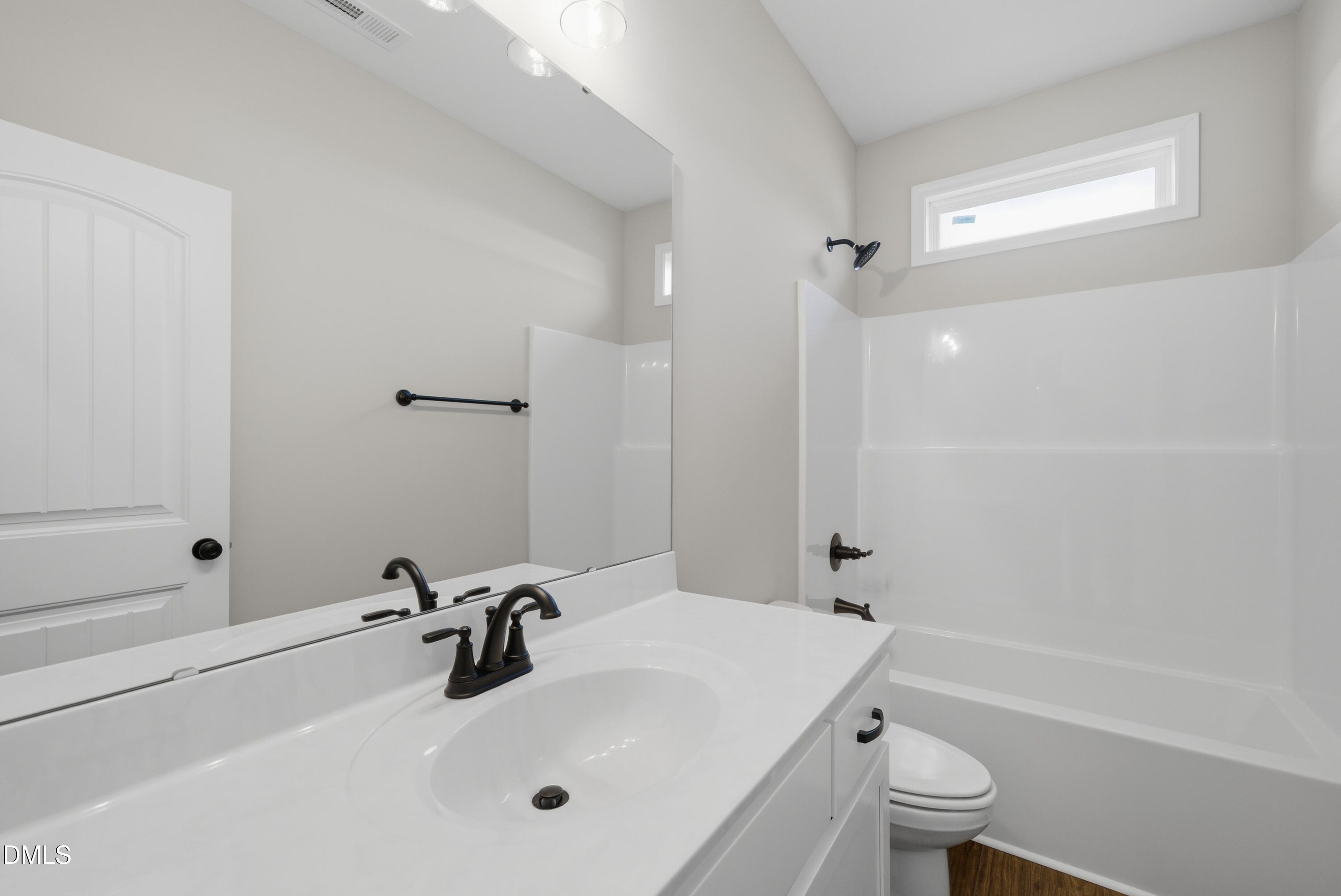 9315 Turkey Way Middlesex, NC 27557 - Photo 21 of 34 a bathroom with a sink a toilet and a bathtub