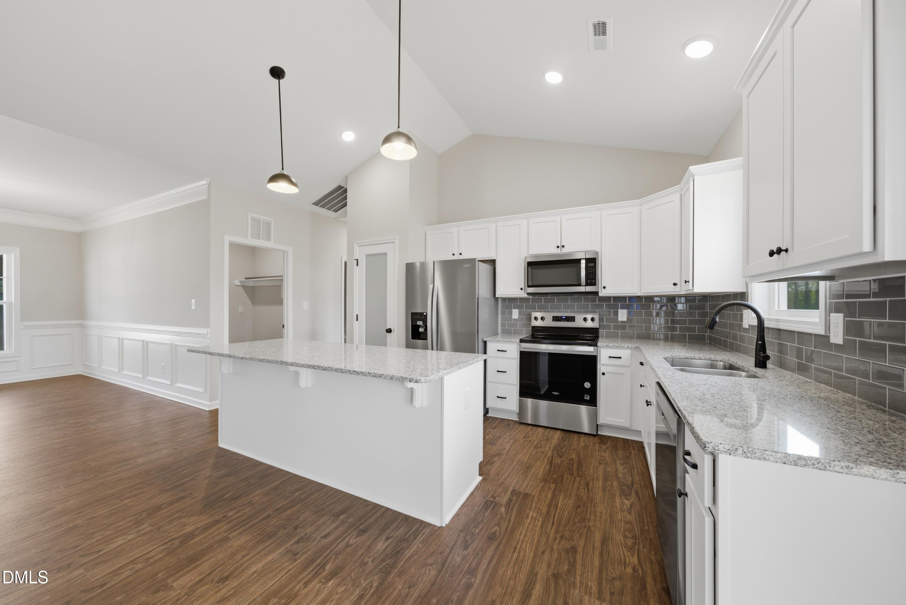 9315 Turkey Way Middlesex, NC 27557 - Photo 4 of 34 a large kitchen with cabinets wooden floor and stainless steel appliances