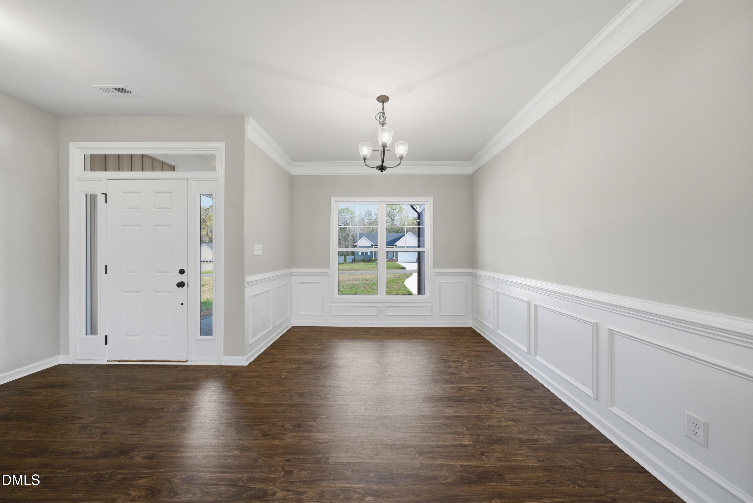9315 Turkey Way Middlesex, NC 27557 - Photo 5 of 34 a view of an empty room with wooden floor and a window