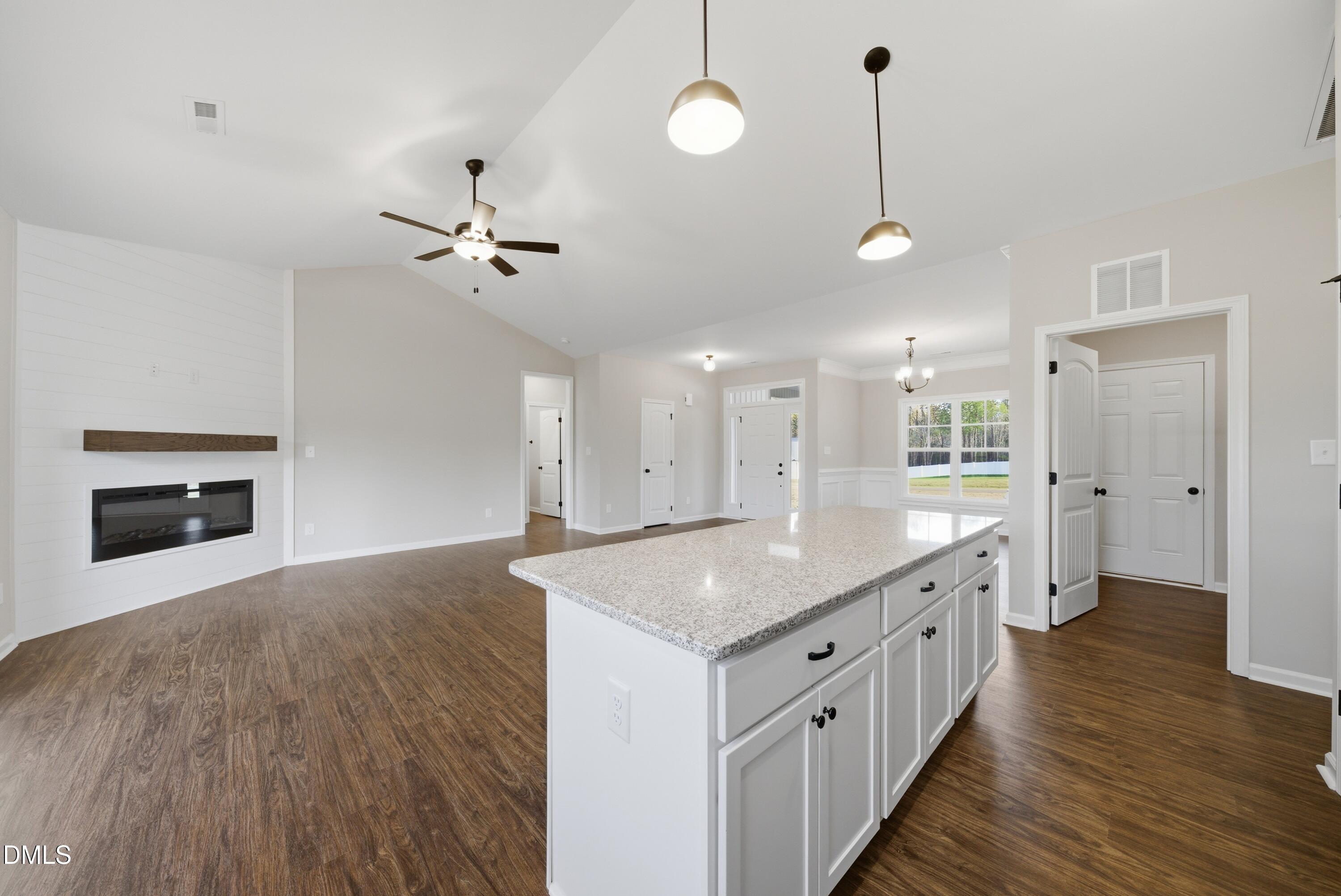 9315 Turkey Way Middlesex, NC 27557 - Photo 9 of 34 an open kitchen with a chandelier and a stove top oven