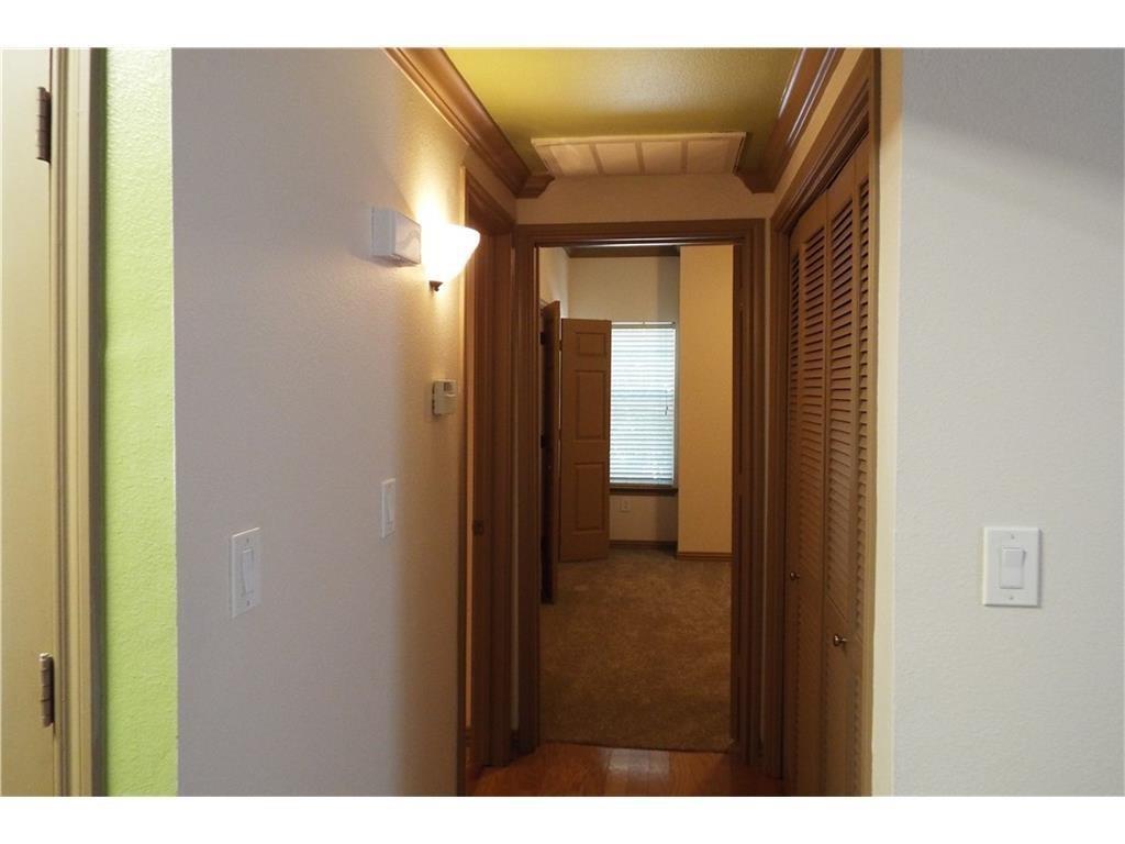 2601 Preston Road, Unit 5209 Plano, TX 75093 - Photo 11 of 18 a view of a hallway with wooden shelves