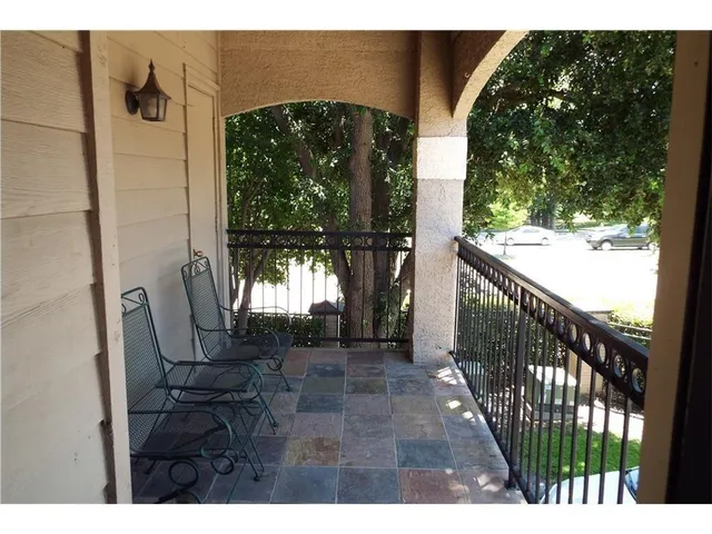 a view of balcony with furniture