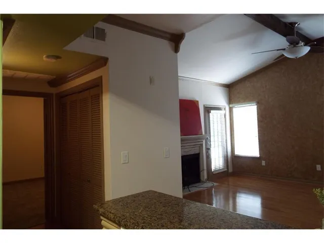 a view of a hallway with wooden shelves