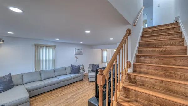 a living room with furniture and stairs
