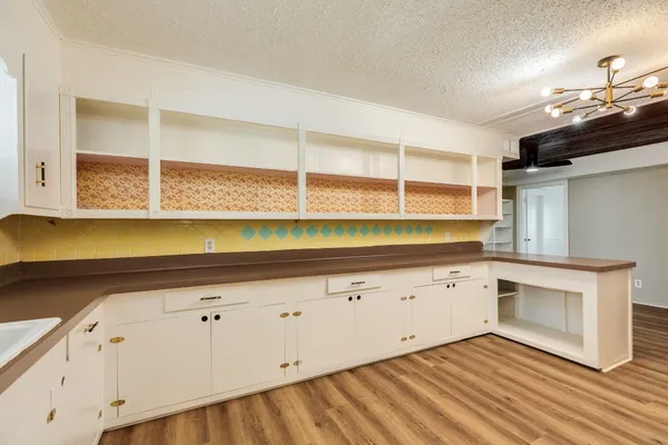 a view of a kitchen with wooden floor and a sink