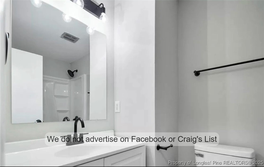 1604 Shaw Road Fayetteville, NC 28311 - Photo 5 of 12 a bathroom with a sink and a mirror