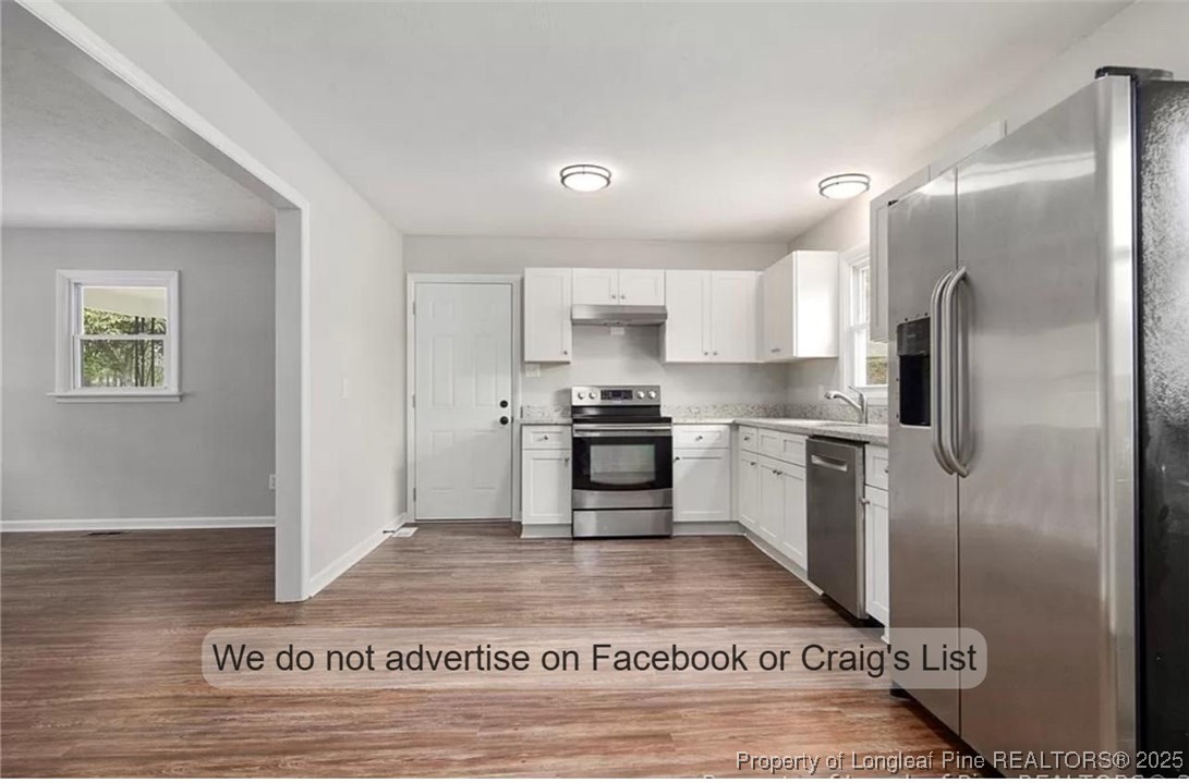 1604 Shaw Road Fayetteville, NC 28311 - Photo 6 of 12 a kitchen with a refrigerator sink and cabinets