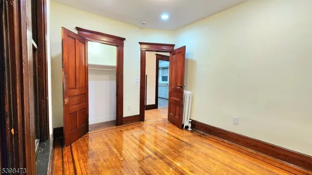a view of a room with a large bed and wooden floor