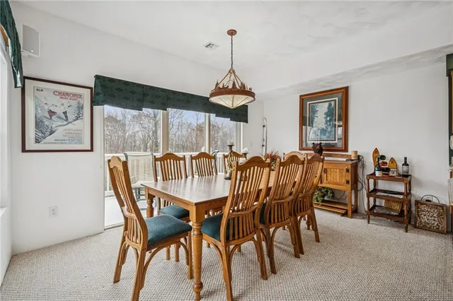 a dining room with furniture and window