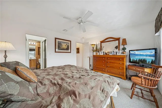 a bedroom with a bed a chair and dresser