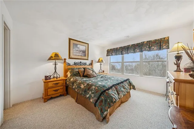 a bedroom with a bed and a mirror