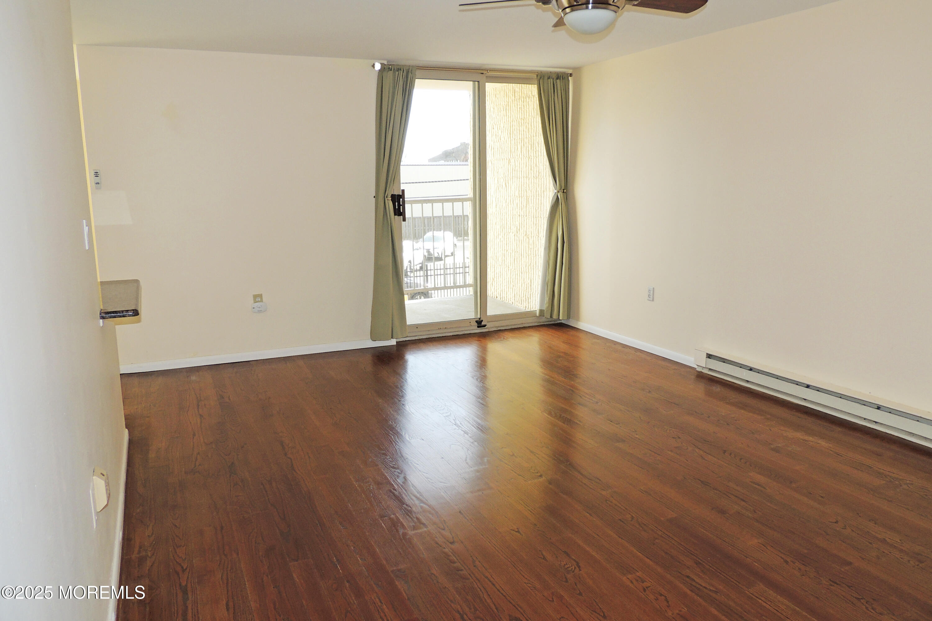 1000 River Road, Unit 2K Belmar, NJ 07719 - Photo 12 of 25 an empty room with wooden floor and windows