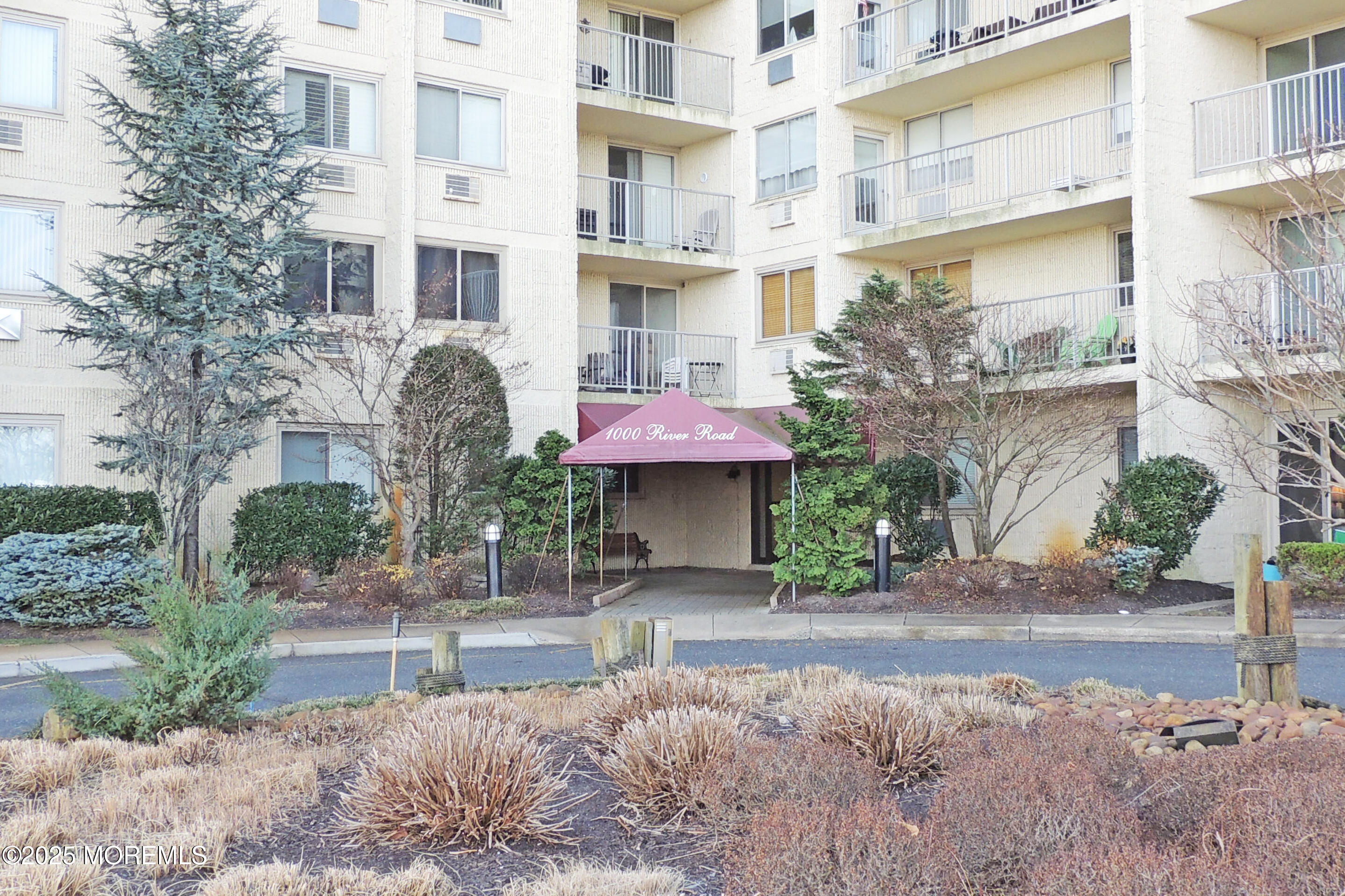 1000 River Road, Unit 2K Belmar, NJ 07719 - Photo 16 of 25 a front view of a building with garden