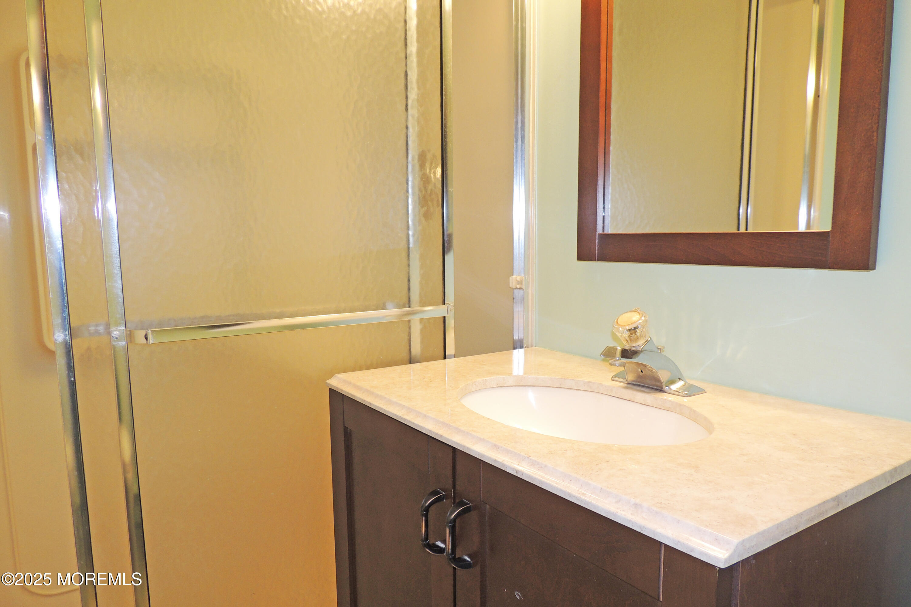 1000 River Road, Unit 2K Belmar, NJ 07719 - Photo 3 of 25 a bathroom with a sink and a mirror