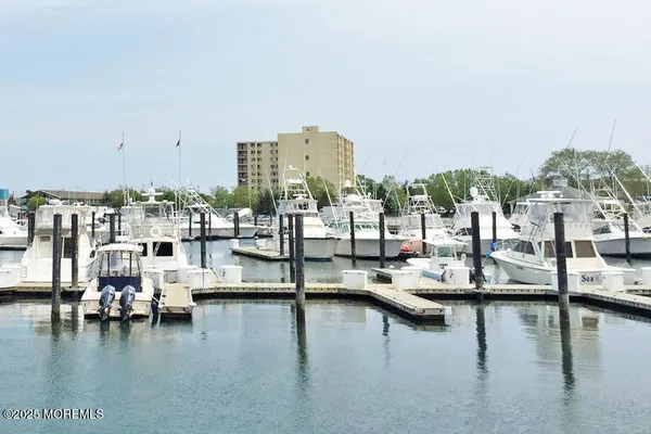 a view of a ocean with boats and palm trees