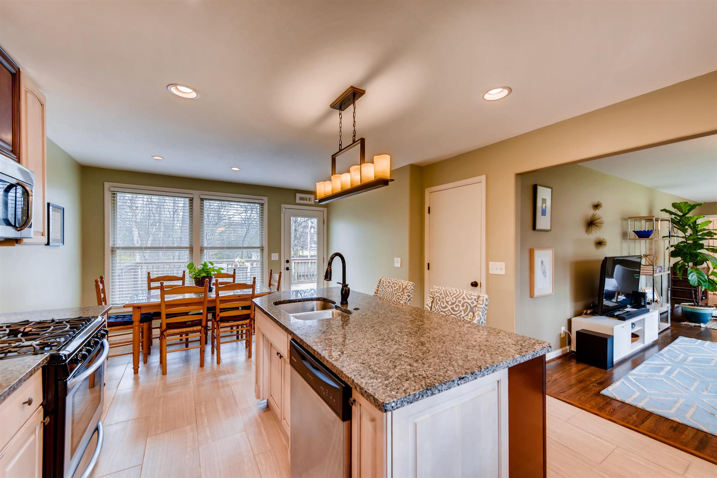 1100 Sparta Road Nashville, TN 37205 - Photo 14 of 29 a kitchen with granite countertop a stove a sink a dining table and chairs with a large window