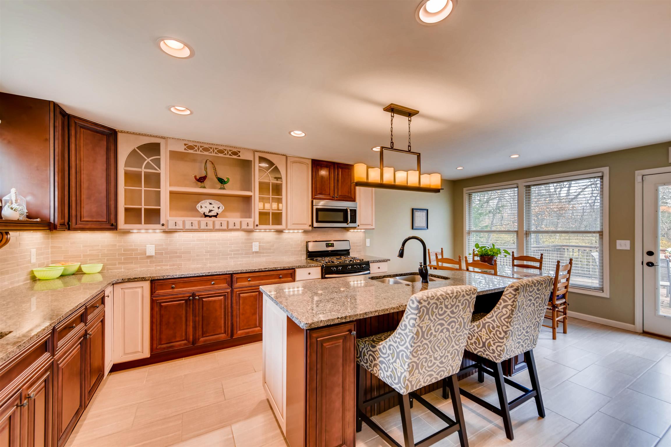 1100 Sparta Road Nashville, TN 37205 - Photo 16 of 29 a kitchen with stainless steel appliances granite countertop a stove a sink a microwave a dining table and chairs