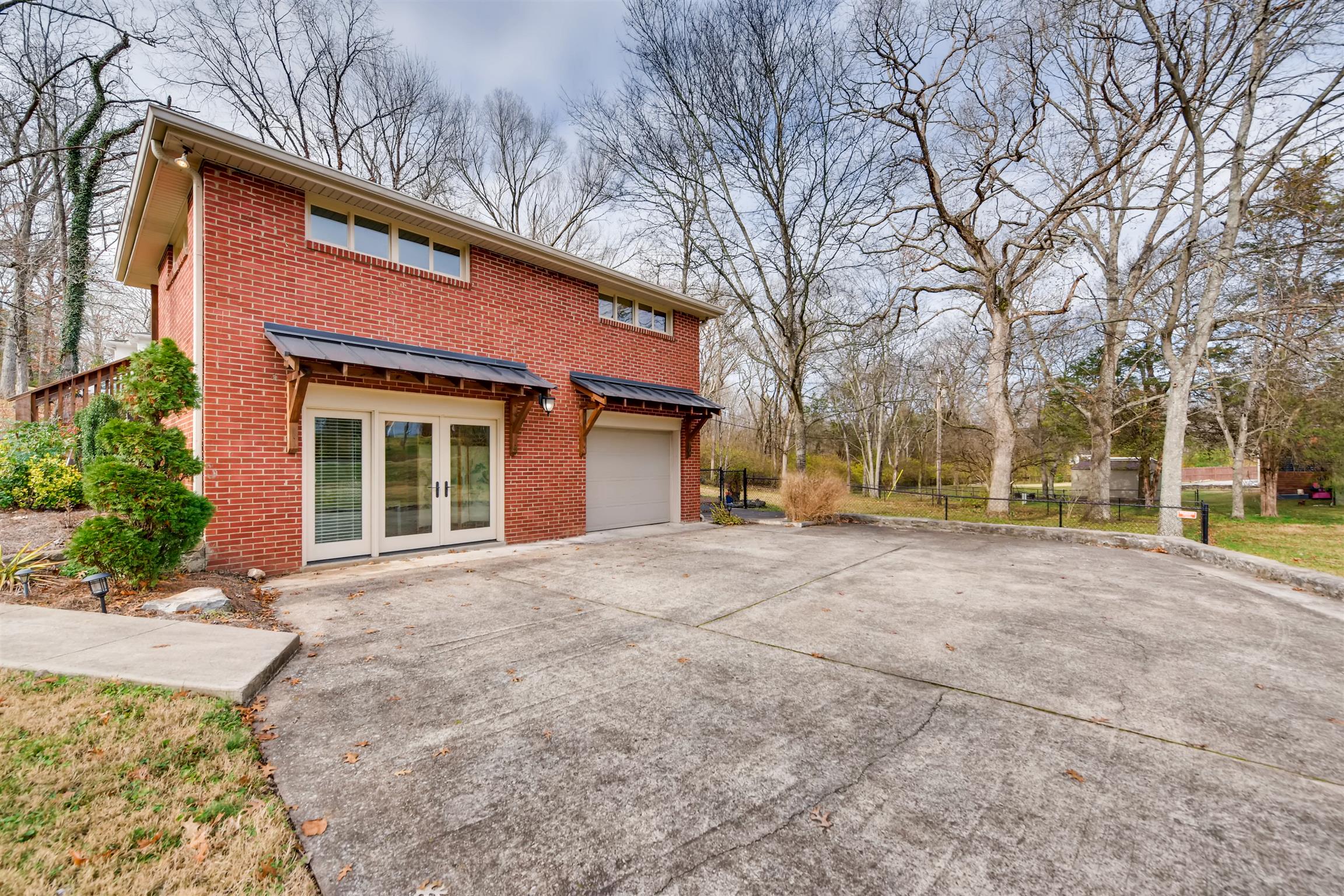 1100 Sparta Road Nashville, TN 37205 - Photo 3 of 29 a view of a house with a yard and garage
