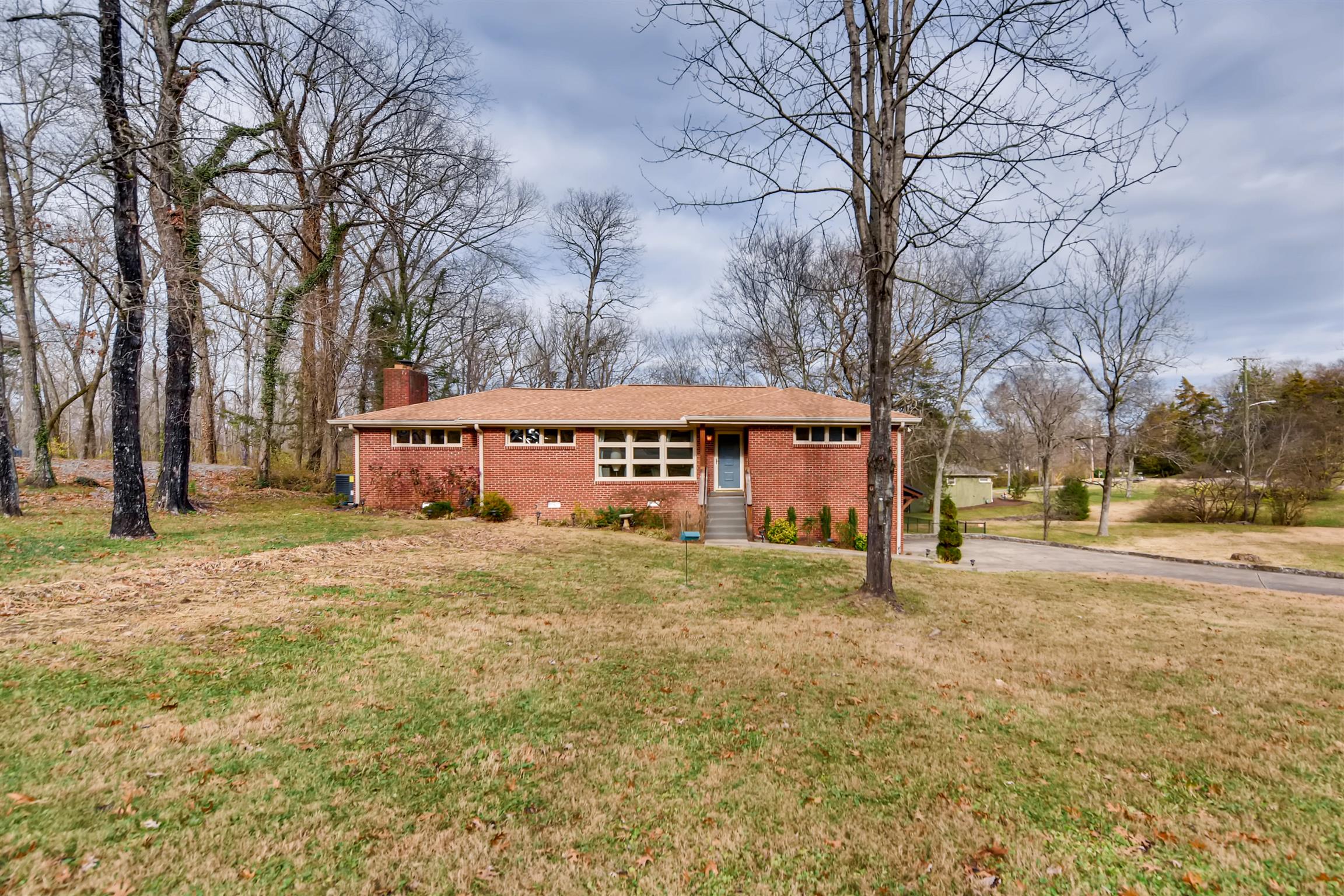 1100 Sparta Road Nashville, TN 37205 - Photo 26 of 29 a view of a large white house with a large tree next to a yard