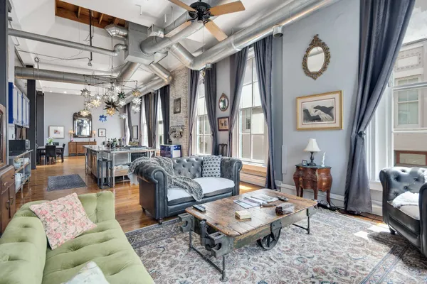 a living room with furniture and a chandelier