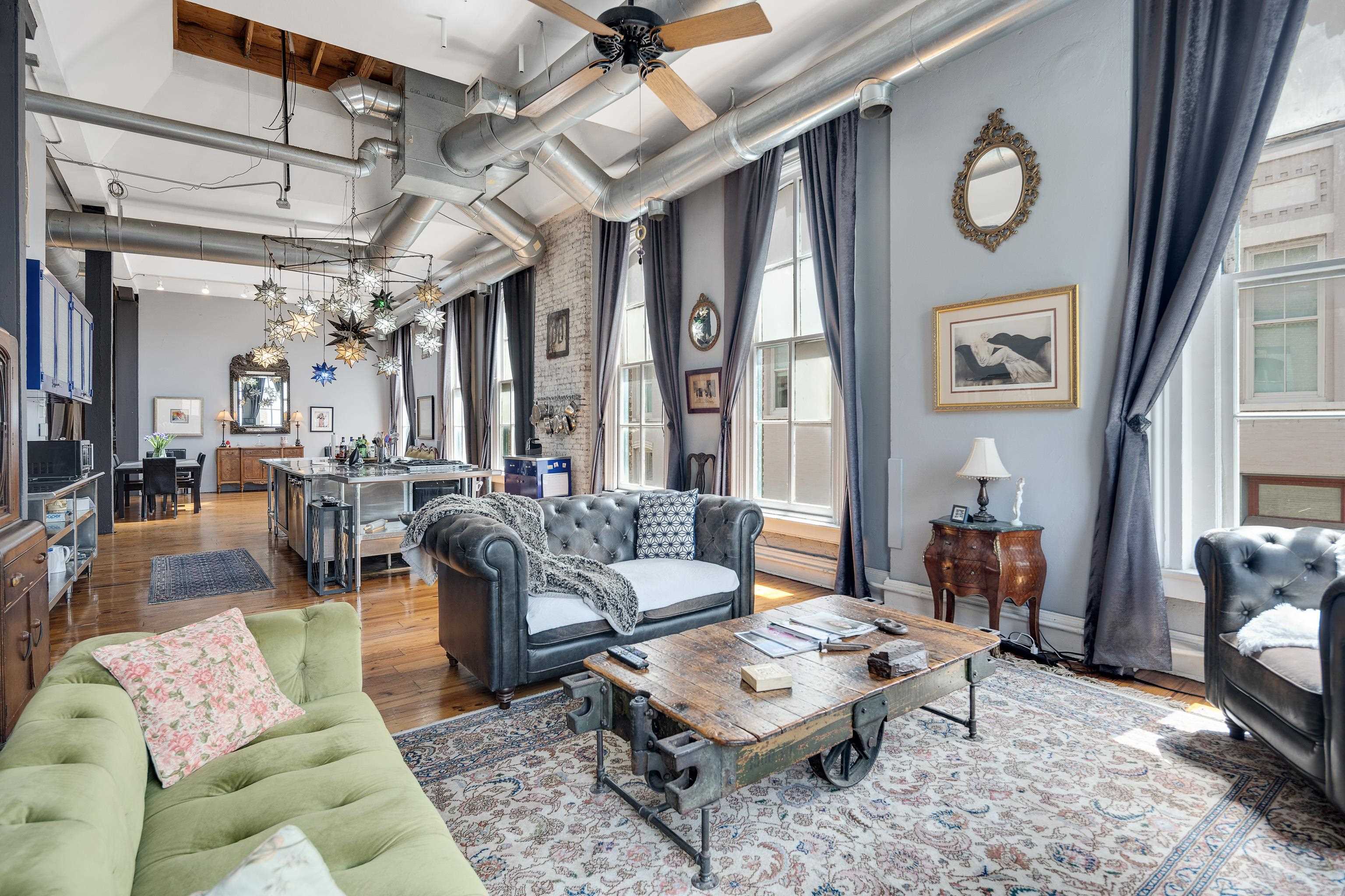 116 South Front Street, Unit 201 Memphis, TN 38103 - Photo 7 of 26 Living area featuring hardwood / wood-style floors, a high ceiling, and ceiling fan