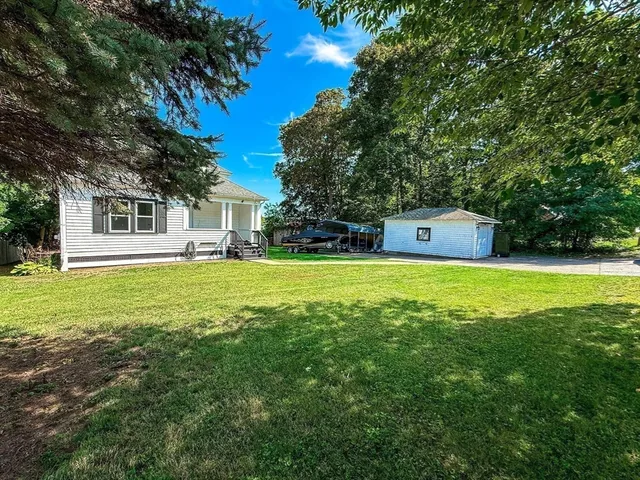 a front view of house with yard and green space