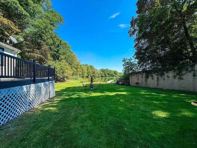 a view of a house with a backyard and a patio