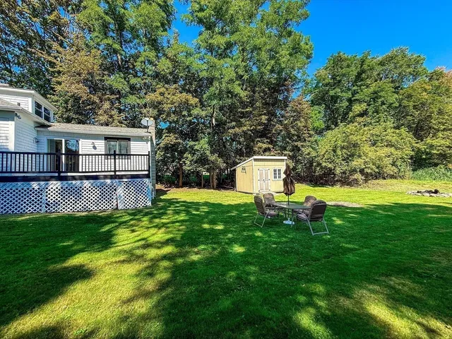 a garden with trees in front of it