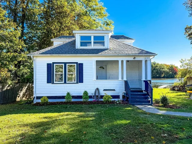 a front view of house with yard and green space